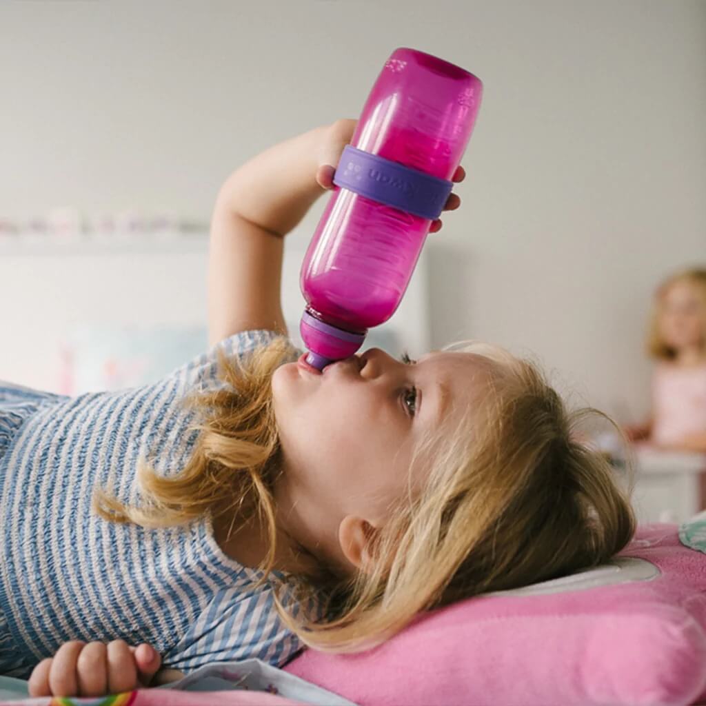 Young Kid drinking from bottle with bottle band